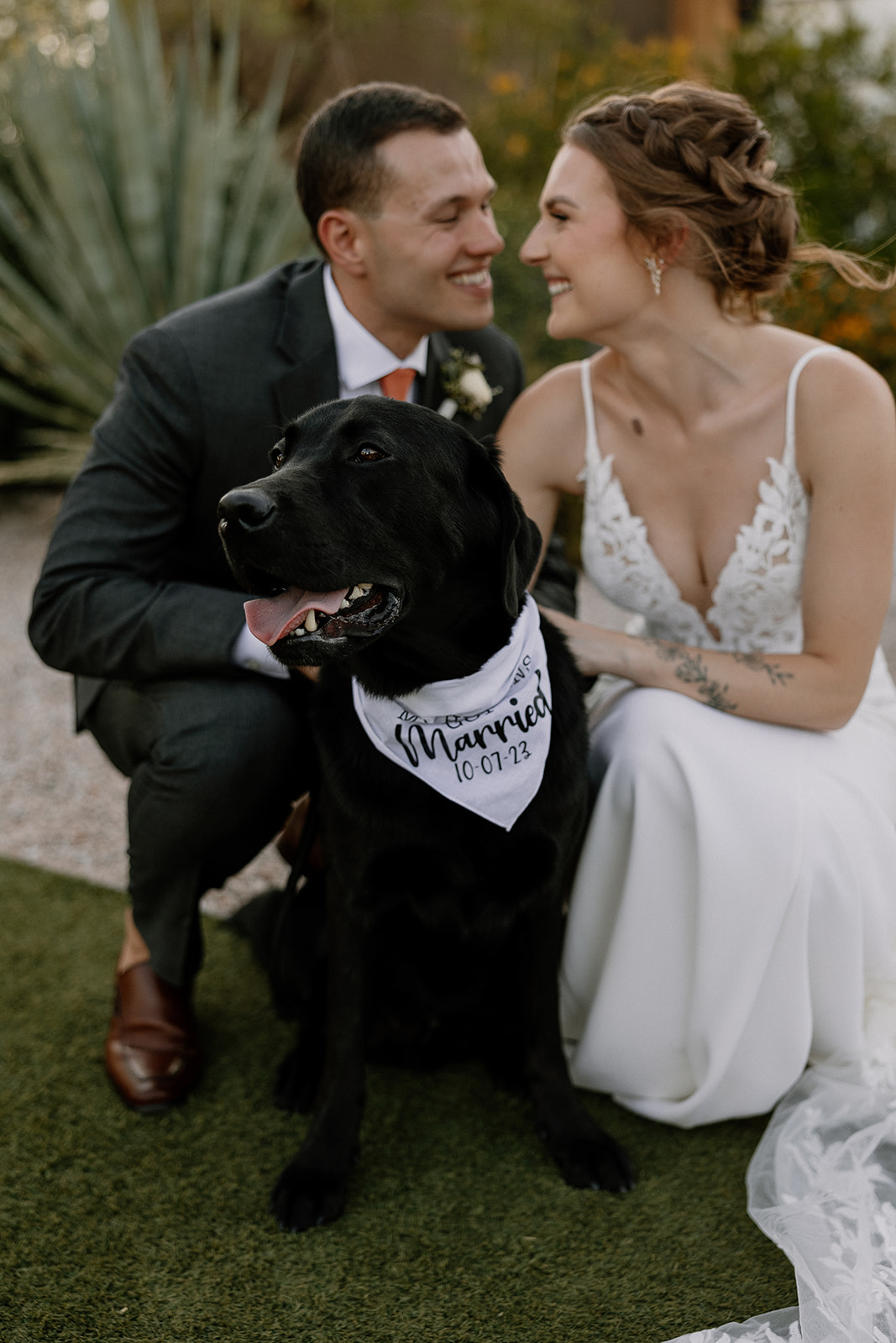 bride and groom pose with their dog