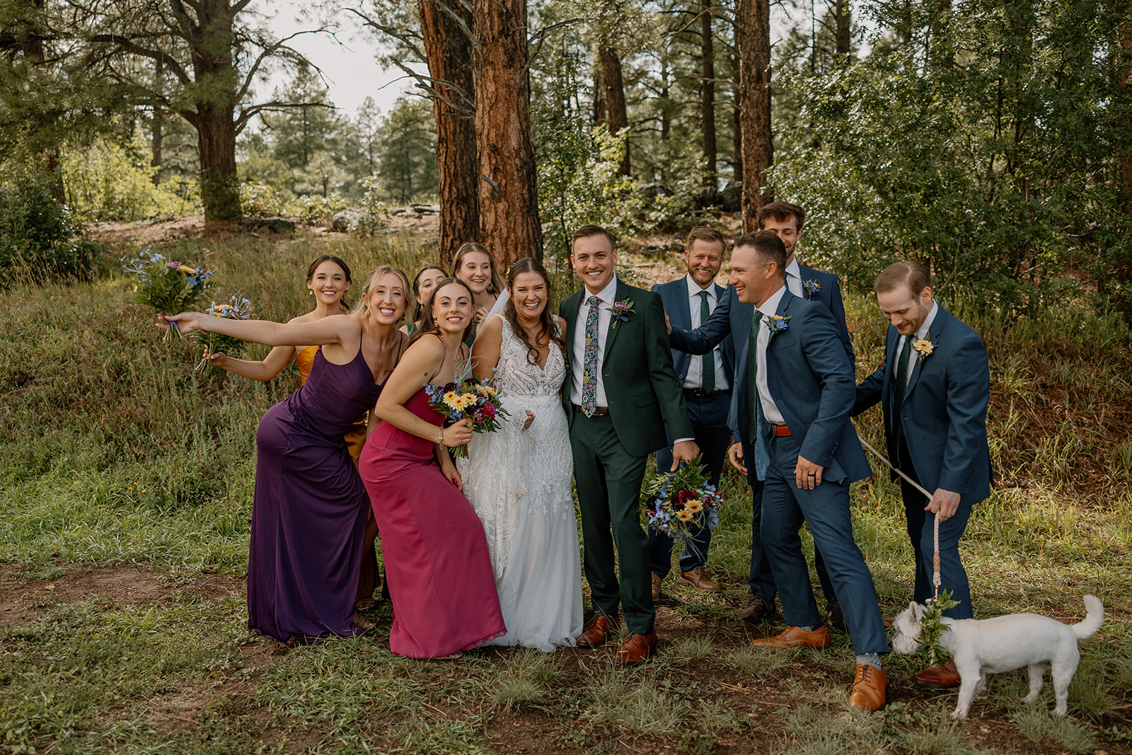 wedding party pose for a photo together outdoor in the foods