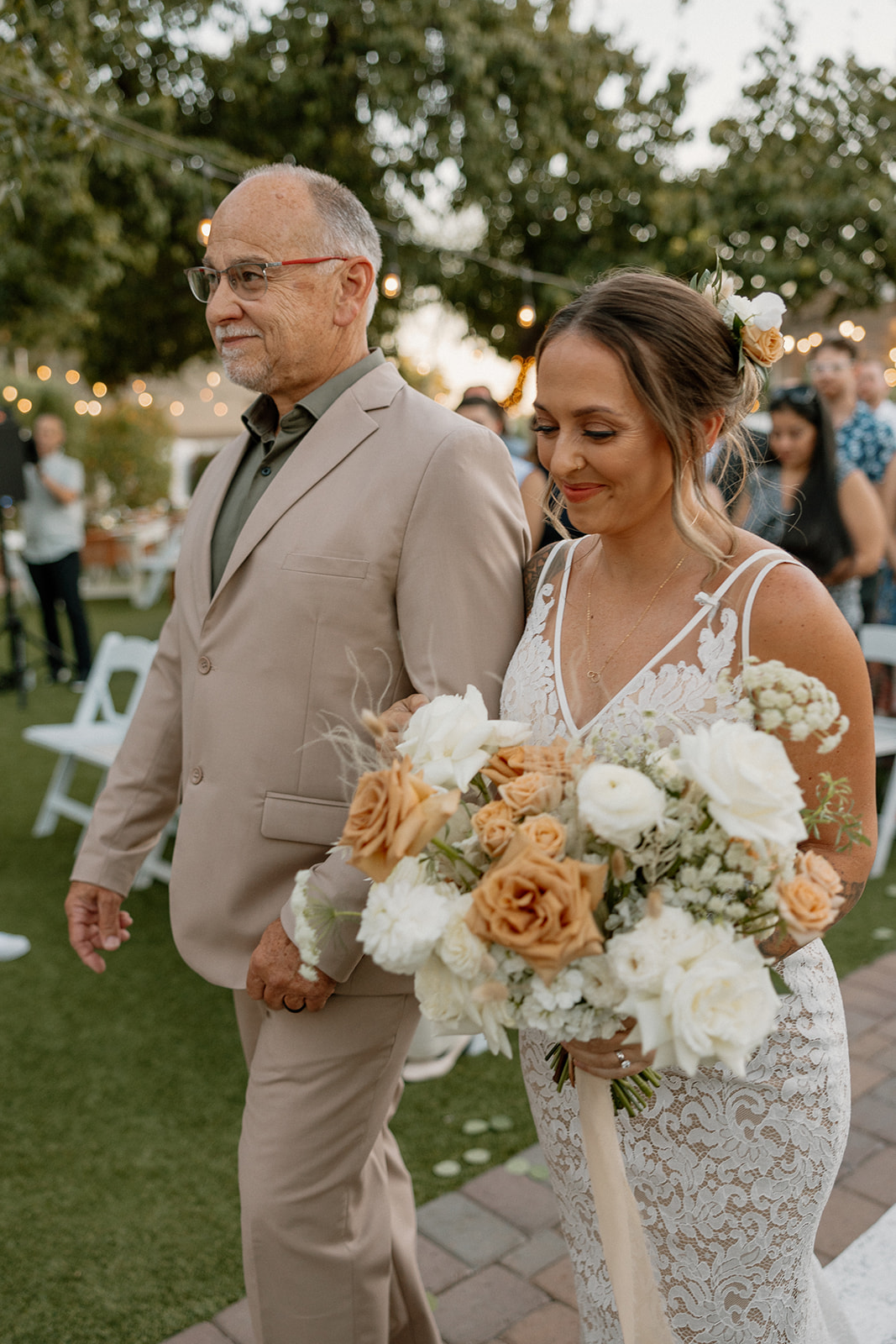 bride walks in with her father to her stunning Arizona wedding day