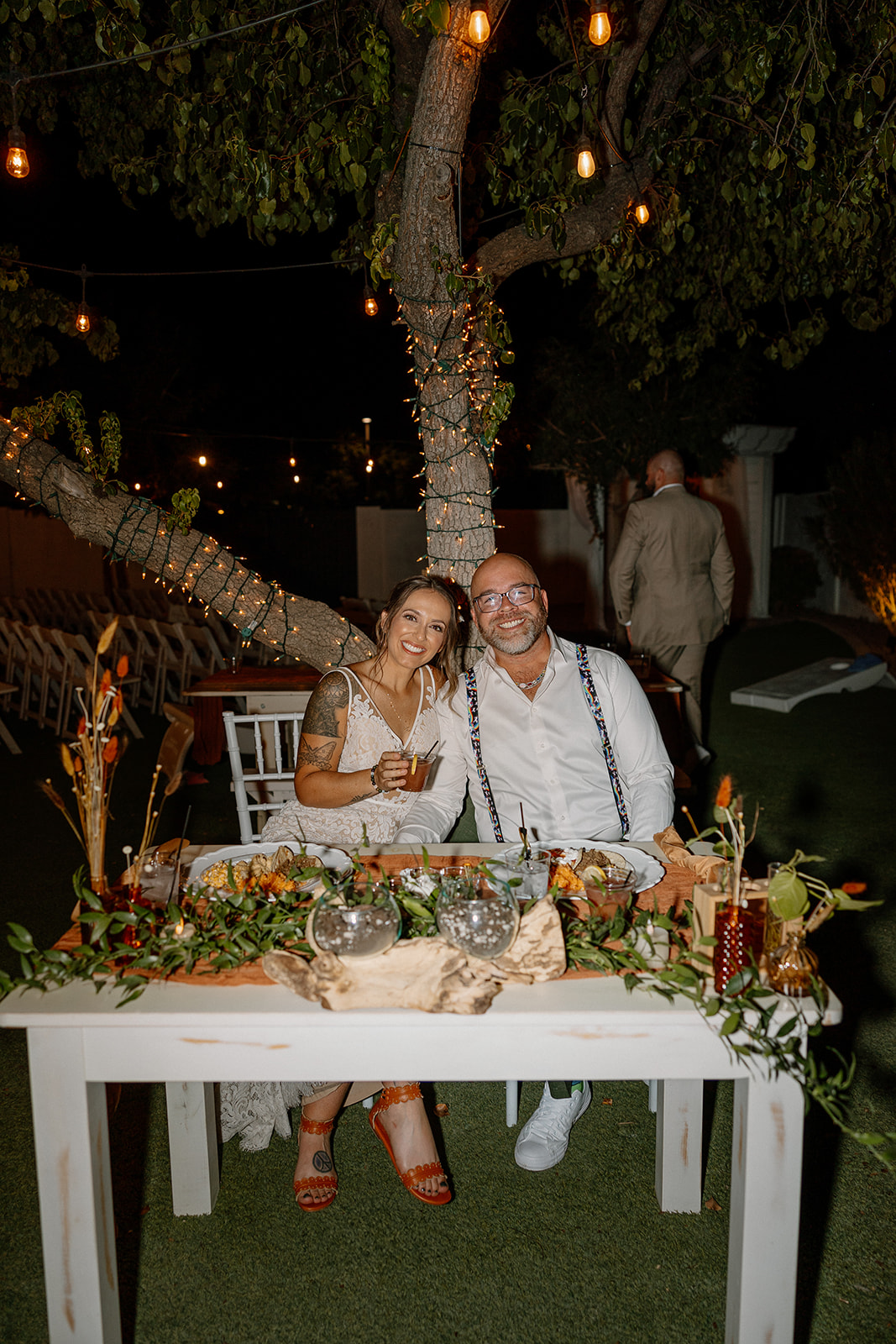 beautiful bride and groom pose for a photo together during their wedding reception