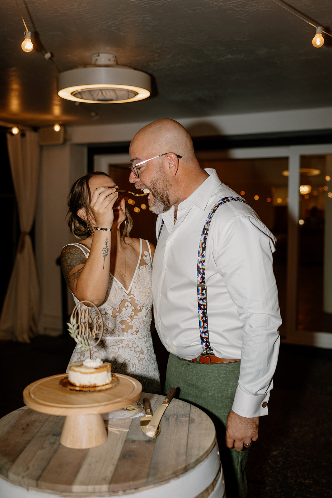 bride and groom share cake together during their timeless wedding reception at The Cottage wedding venue