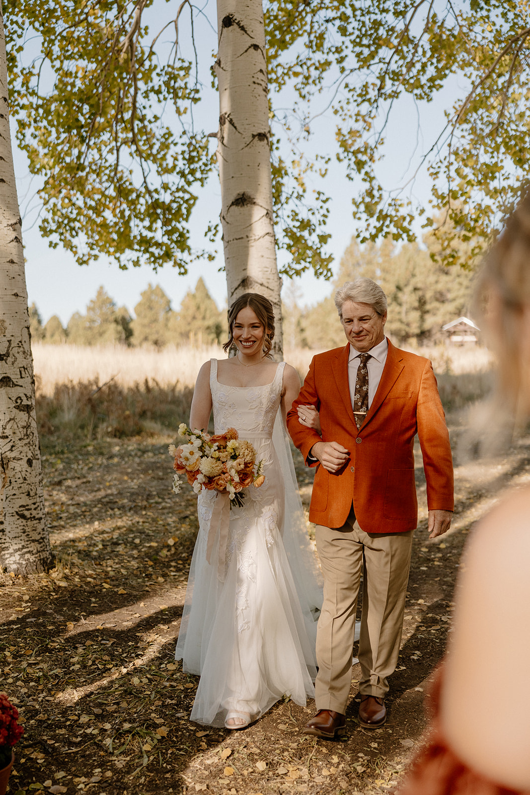 dad brings his daughter into her stunning forest Arizona wedding ceremony