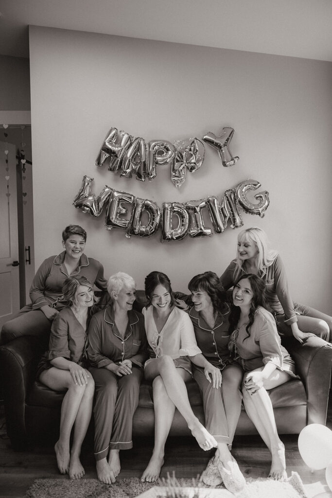 beautiful bride poses with her bridesmaids before they prepare for the stunning Arizona wedding day