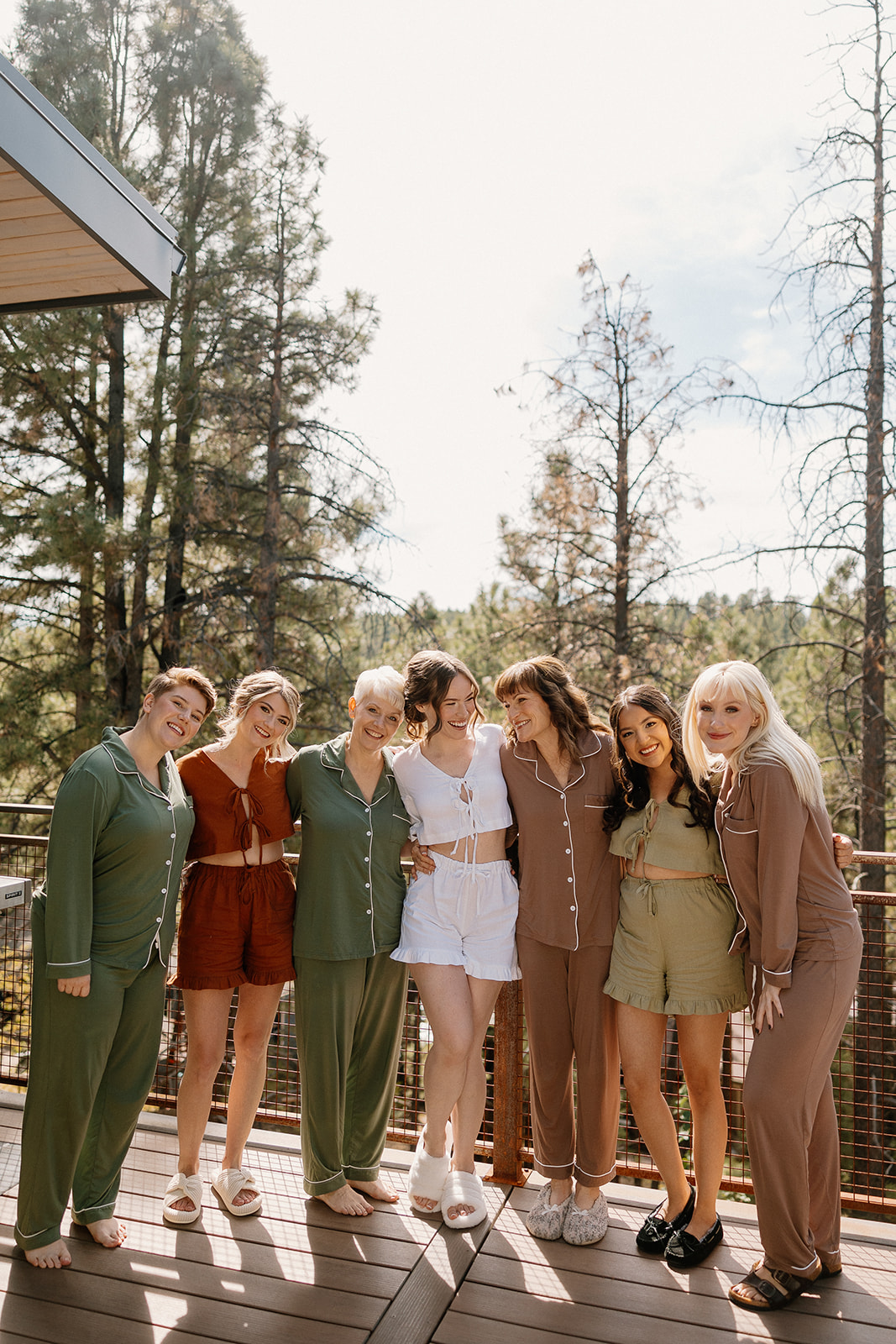 beautiful bride poses with her bridesmaids before they prepare for the stunning Arizona wedding day