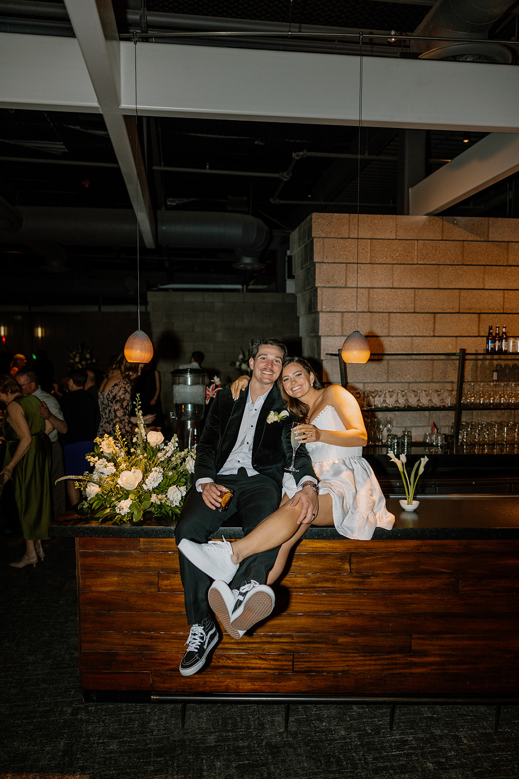 bride and groom on bar celebrating and laughing together