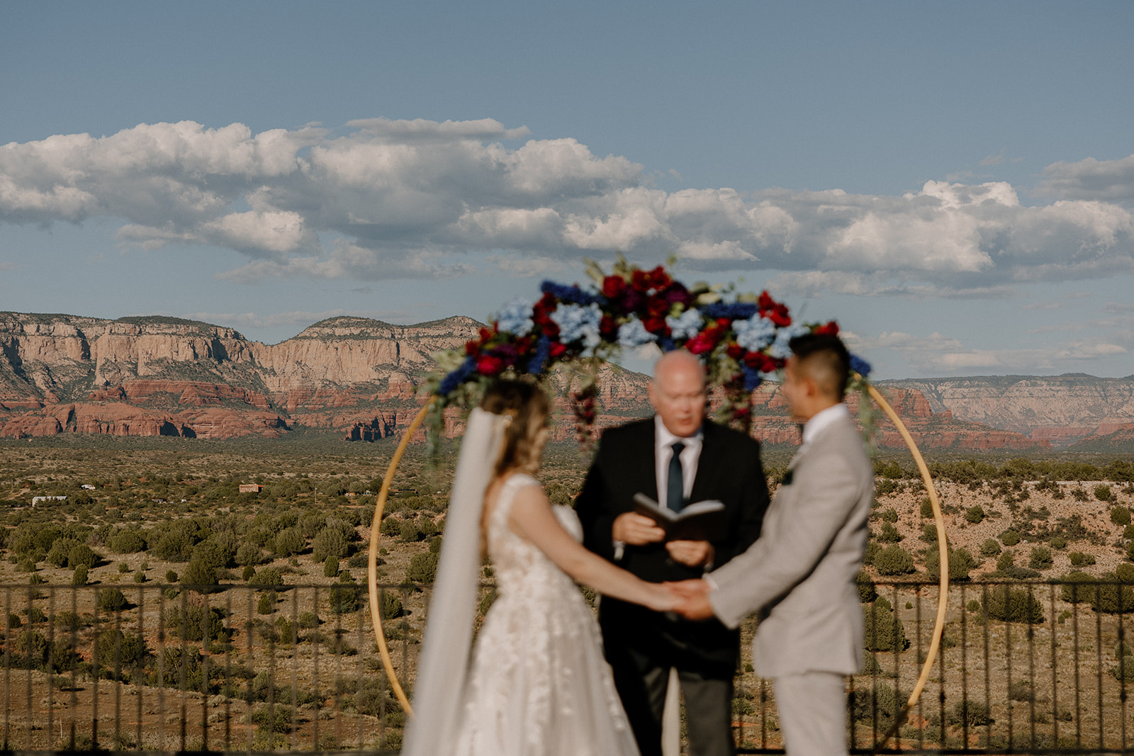 Couple holding hands at altar with incredible view of Arizona scenery and nature