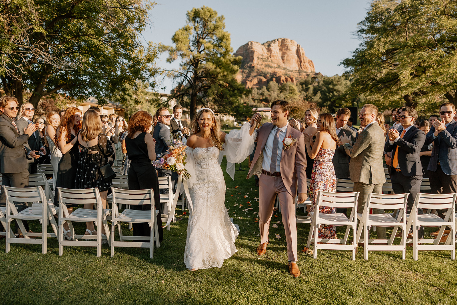 man and woman celebrate and exit wedding ceremony as newly married couple at