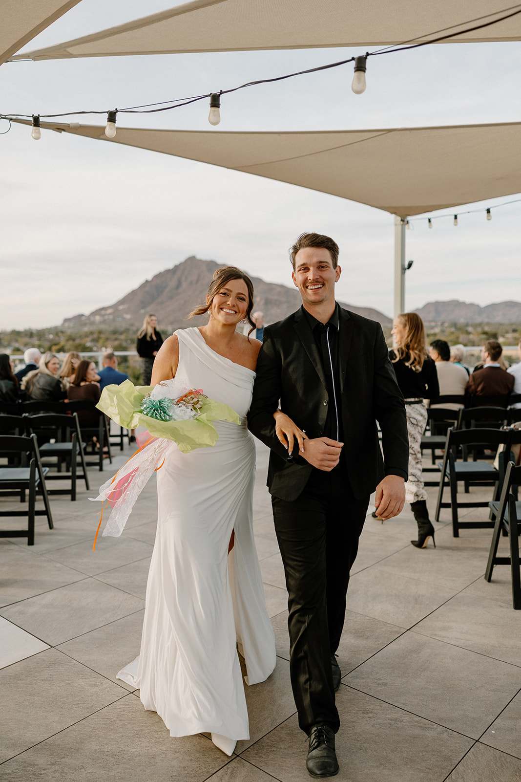 bride and groom walking out of ceremony together