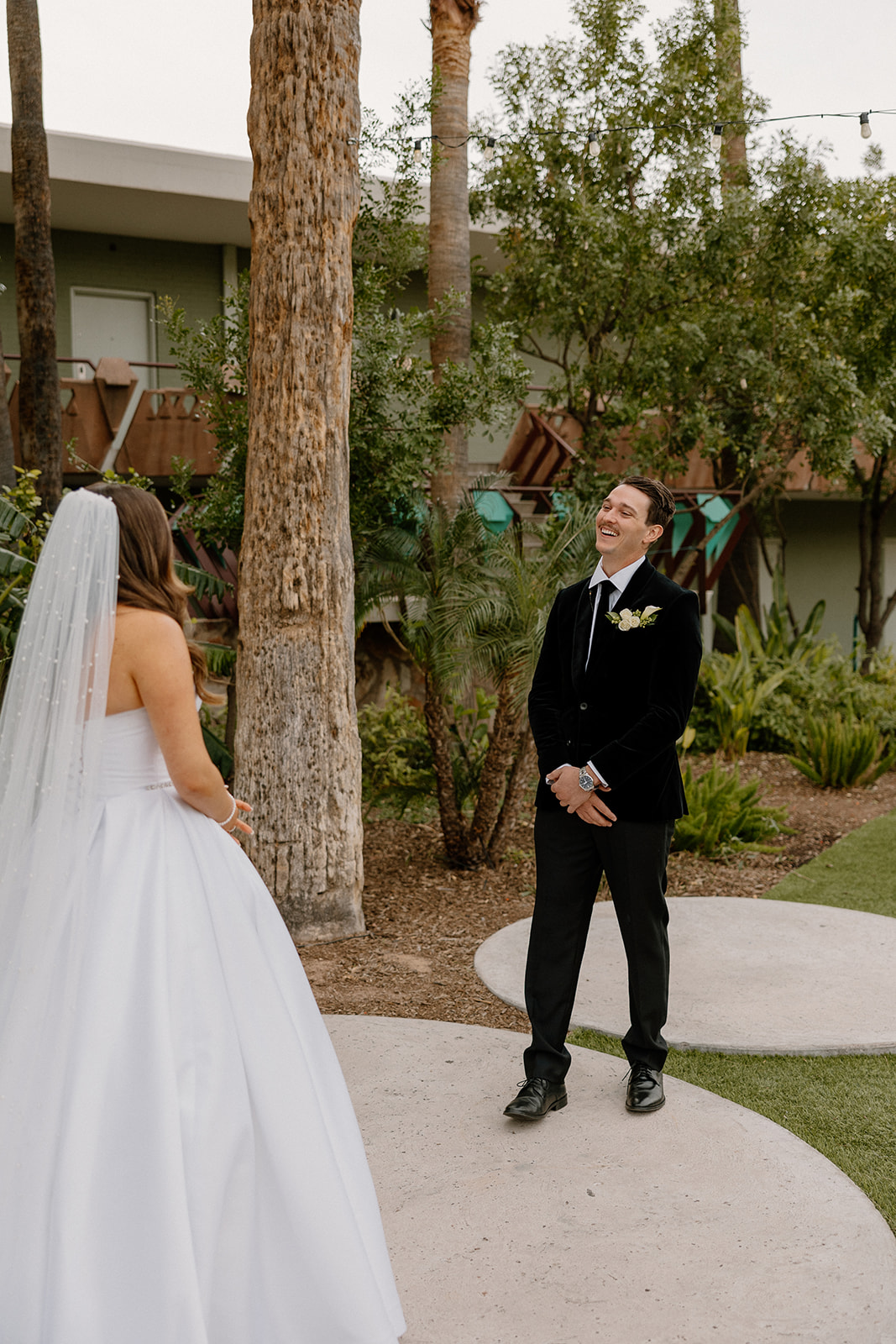 Groom sees bride for first time in wedding gown during first look