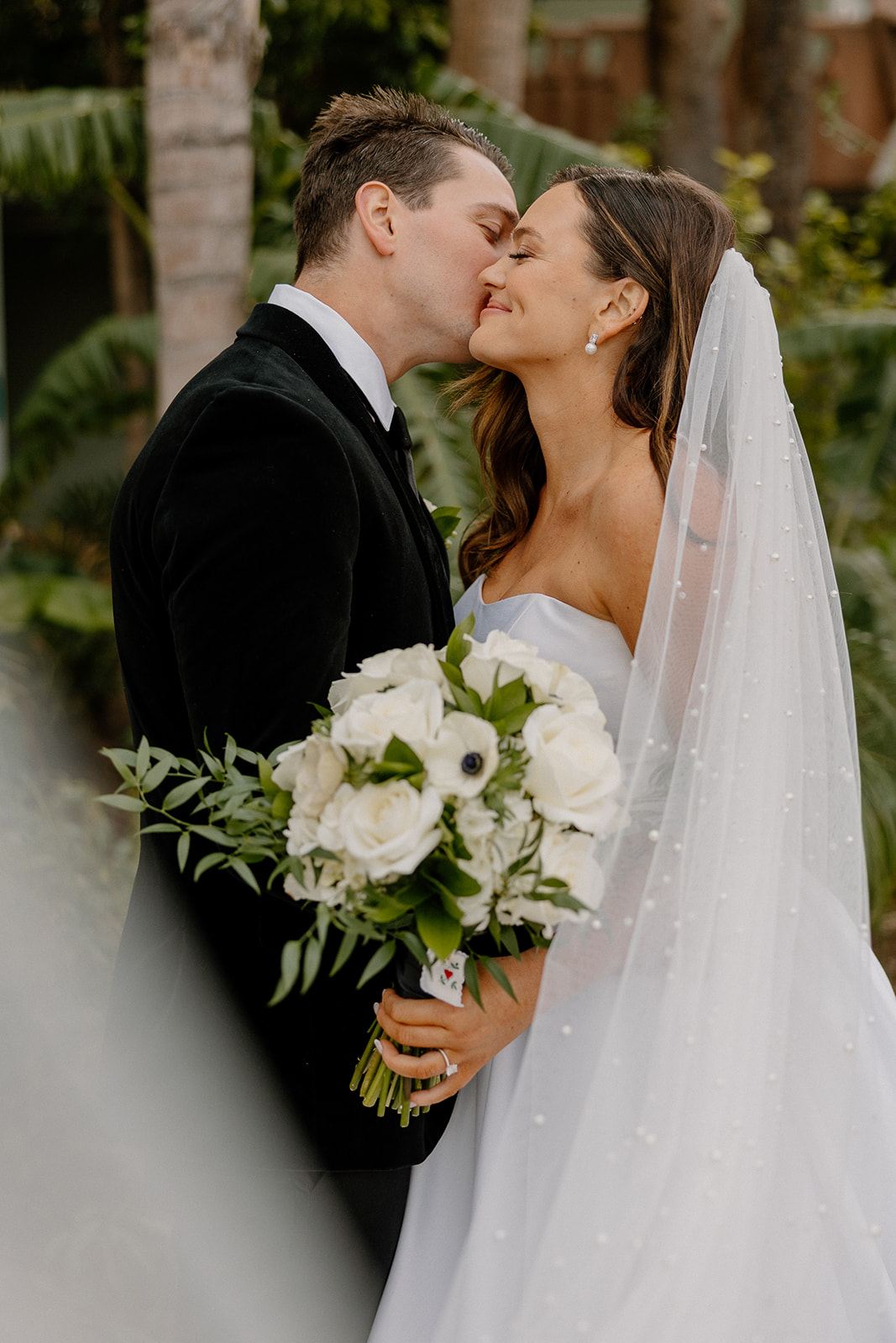 groom kissing bride's cheek before Hotel Valley Ho wedding