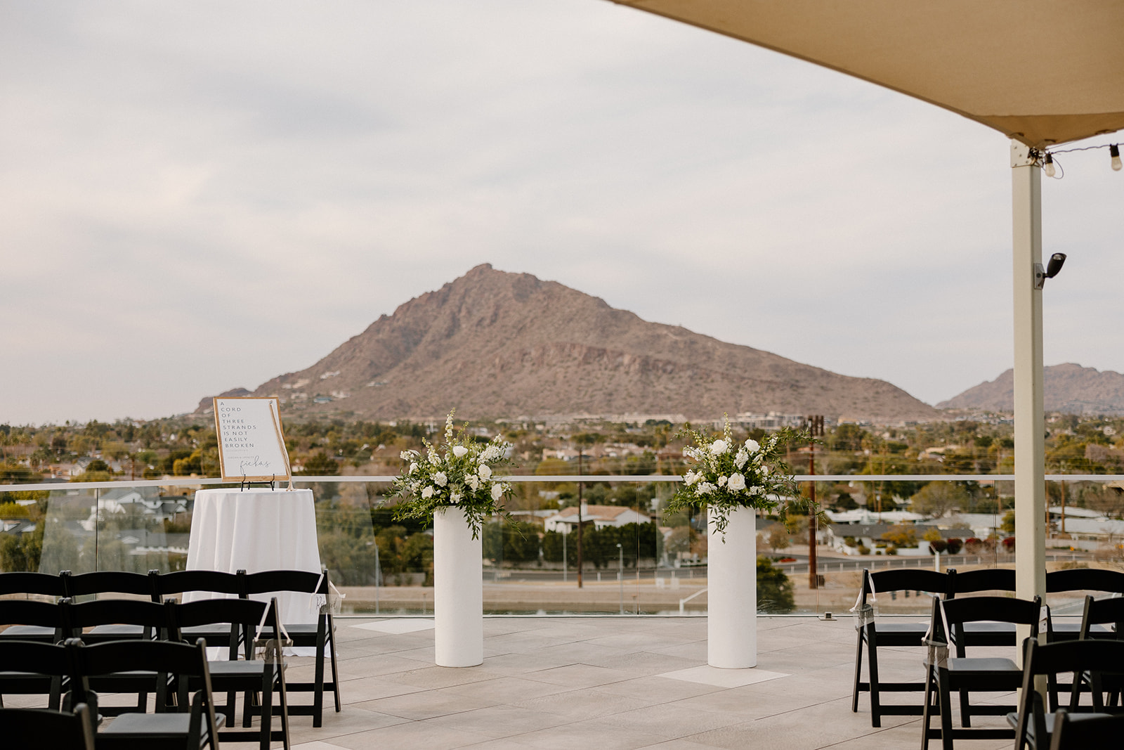Rooftop wedding ceremony view of mountains and sunset 