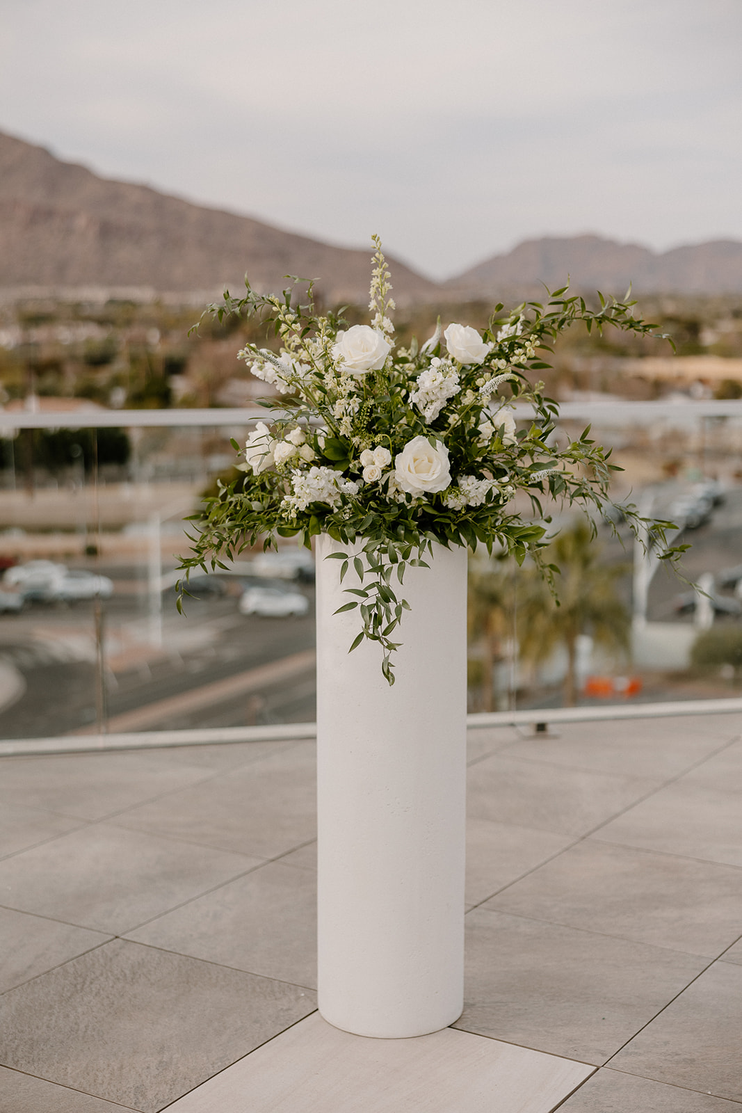 Tall centerpiece standing on white alter on rooftop at Hotel in Scottsdale