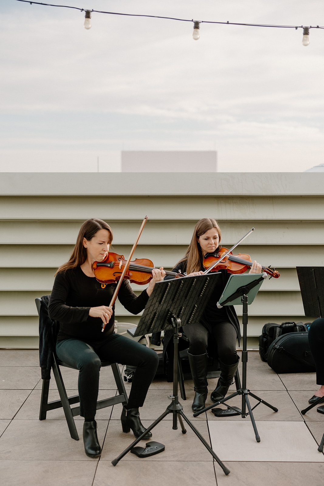 two violinists playing together before rooftop ceremony at Hotel Valley Ho wedding in Scottsdale 