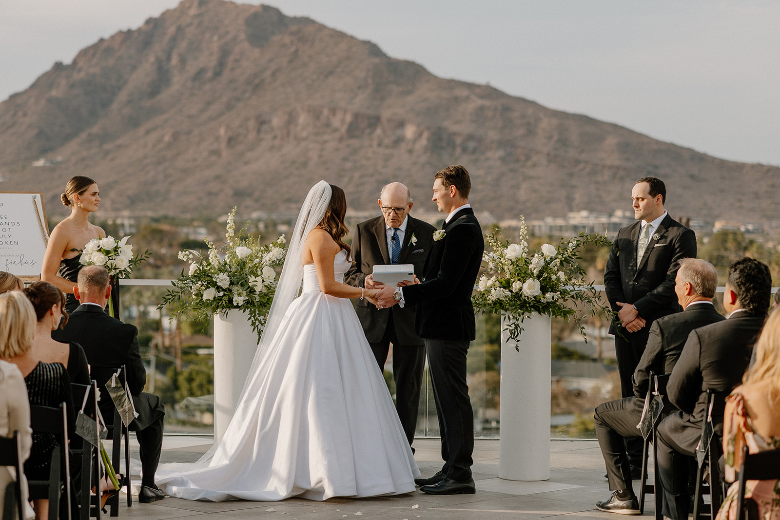 couple holding hands at rooftop ceremony during wedding ceremony
