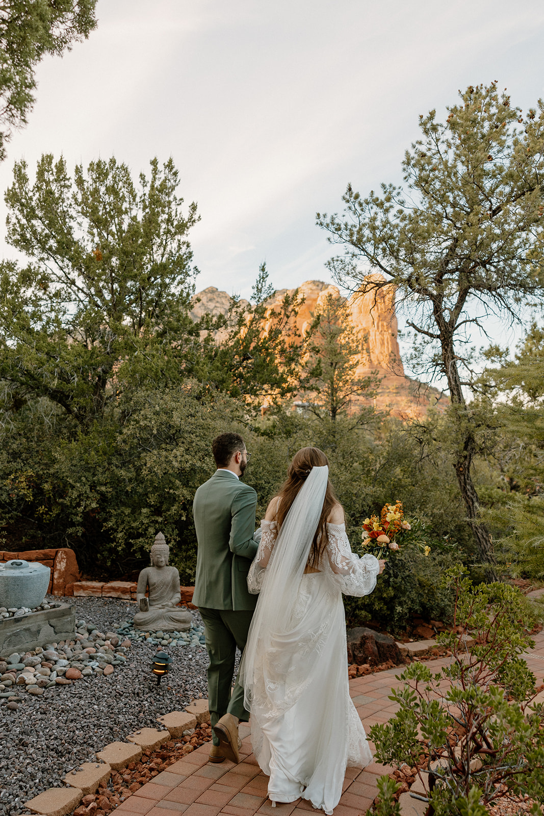Newly married couple walking hand in hand after intimate ceremony at top wedding venues in Sedona - Eagle Dancer
