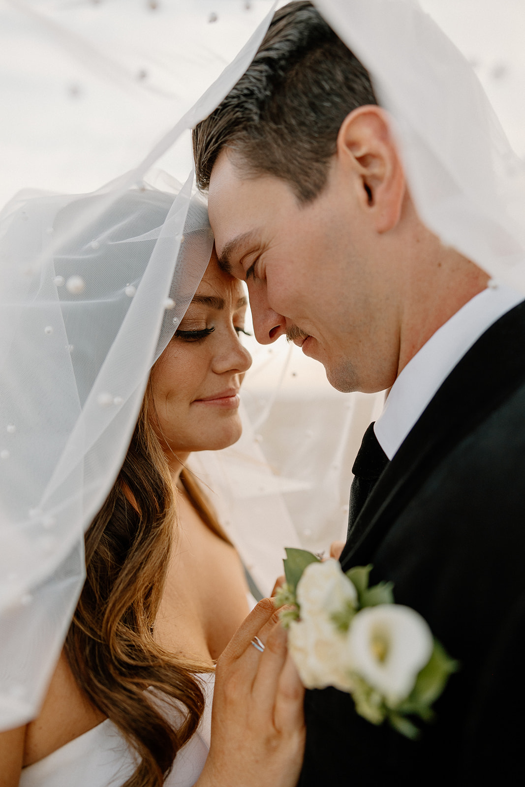 bride and groom under veil forehead to forehead after Hotel Valley Ho wedding