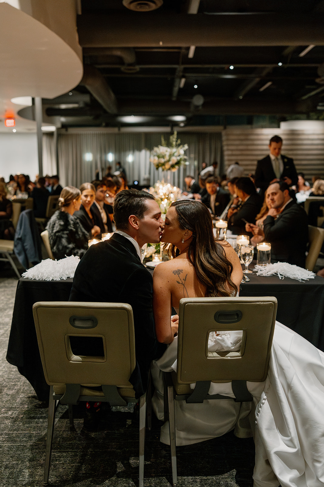 couple kissing at head of table during evening Hotel Valley Ho wedding reception