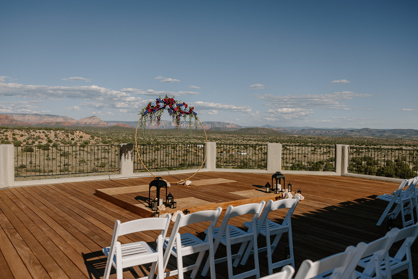 Wedding ceremony set up at The Sanctuary at Sacred Mesa with white chairs facing the Arizona landscape behind them