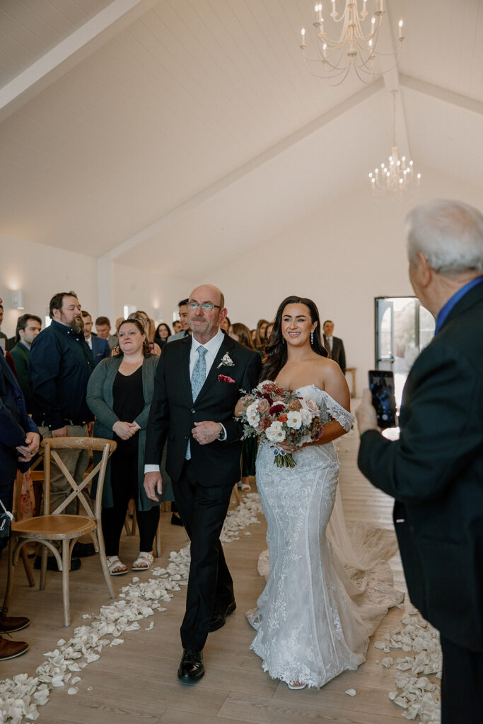 bride is walked down the aisle by her father as her Arizona wedding day begins