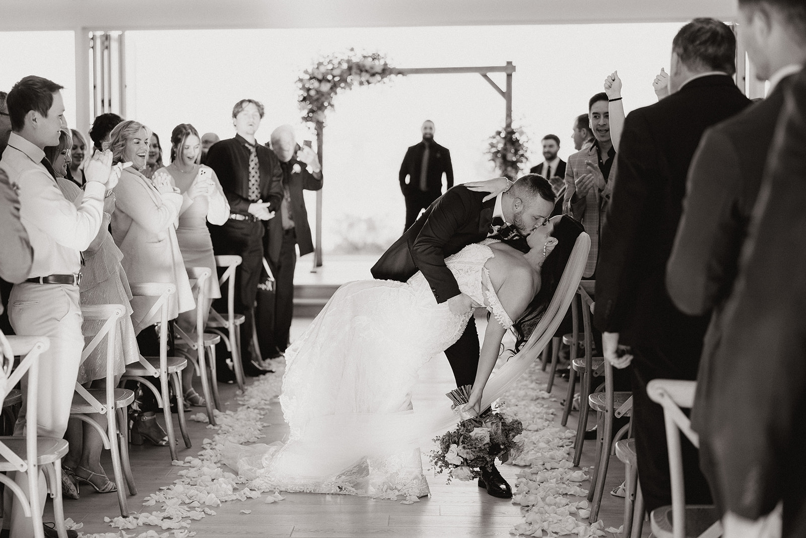 bride and groom share a kiss as they exit their Arizona wedding ceremony