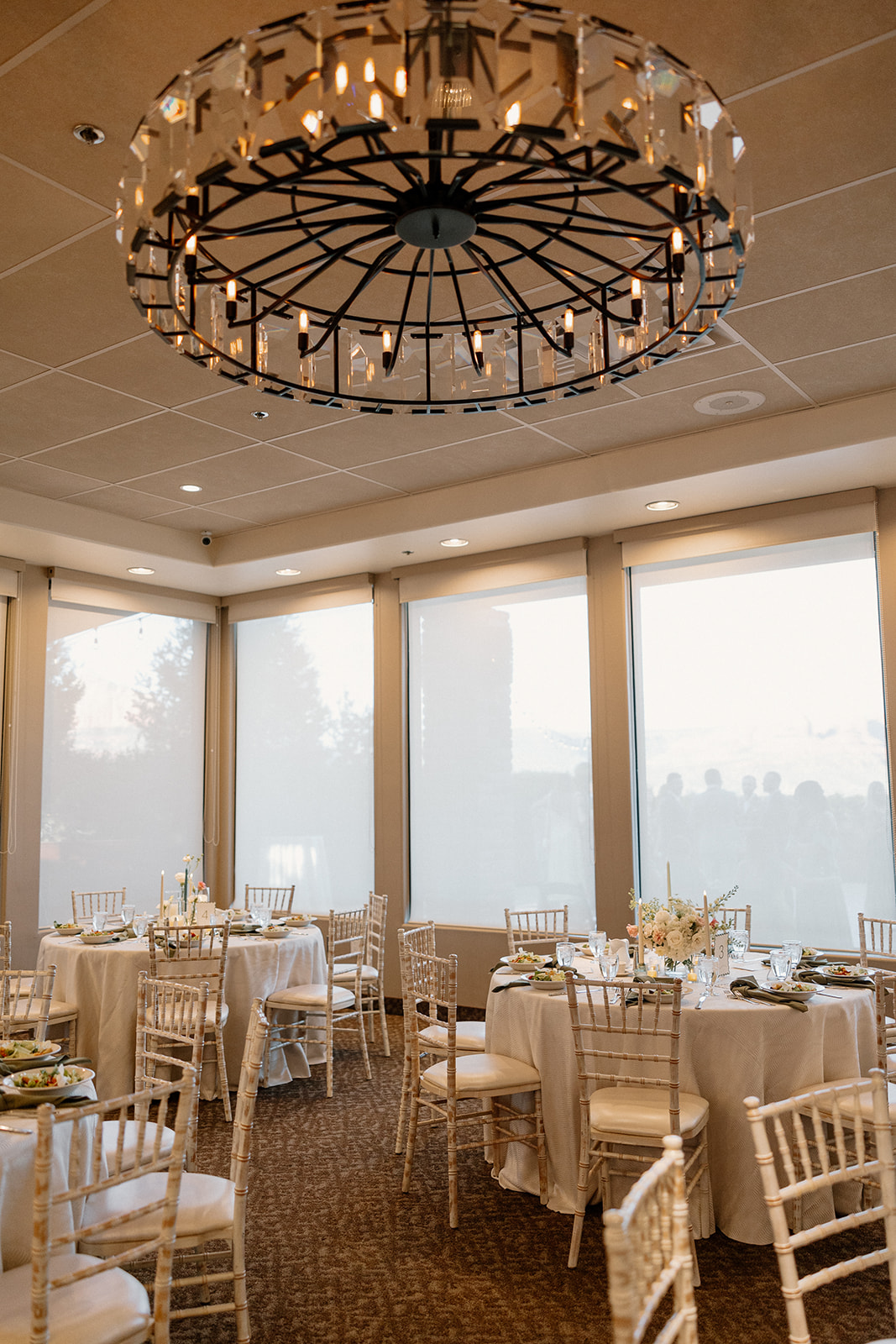 indoor wedding reception with floor to ceiling windows