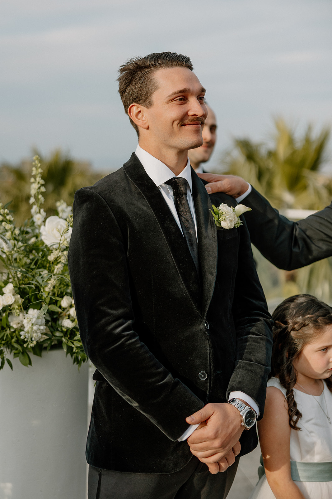 groom smiling while waiting at the alter for his bride to walk down the aisle