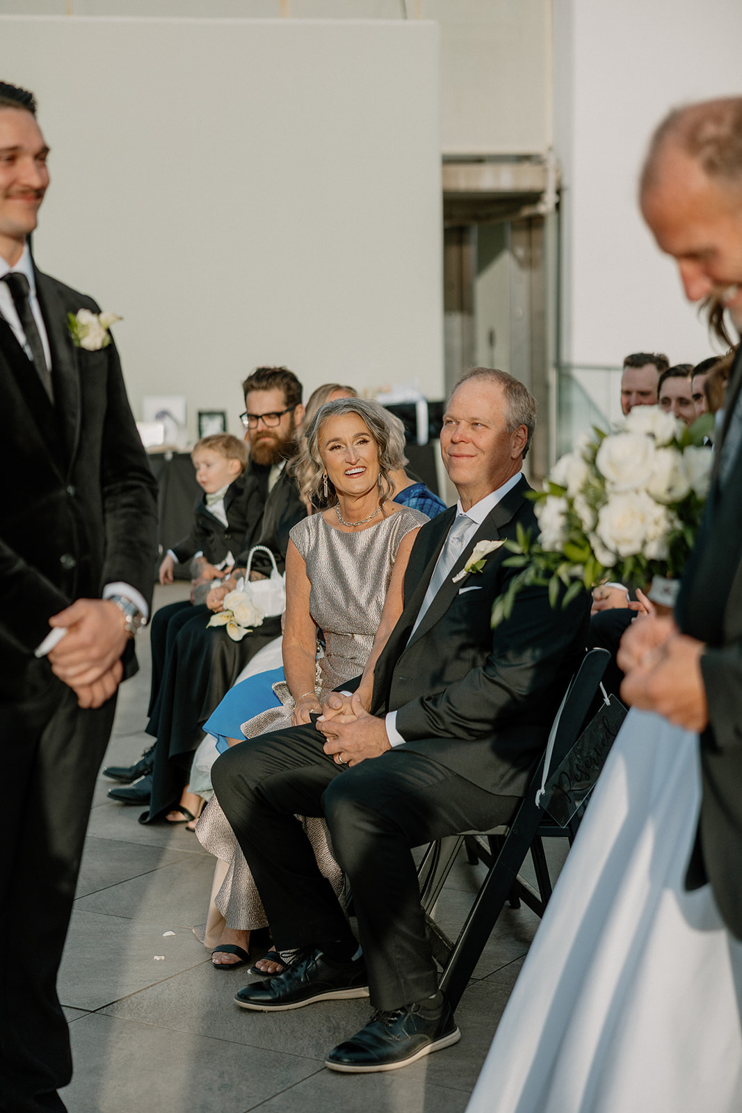 wedding guests watching the bride and groom's reactions to one another as they meet at the ceremony spot