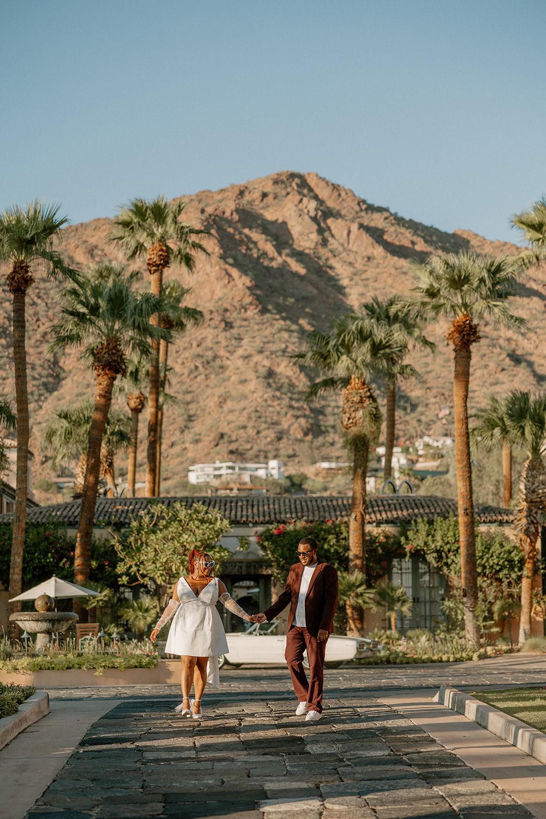 beautiful couple walk outside the Royal Palms Resort