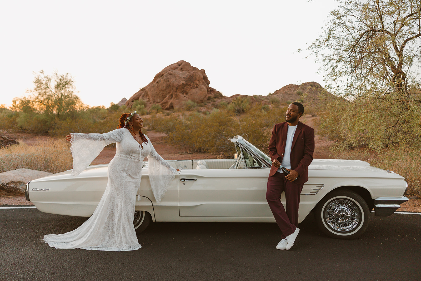 beautiful couple pose next to a vintage car during their timeless engagement photoshoot