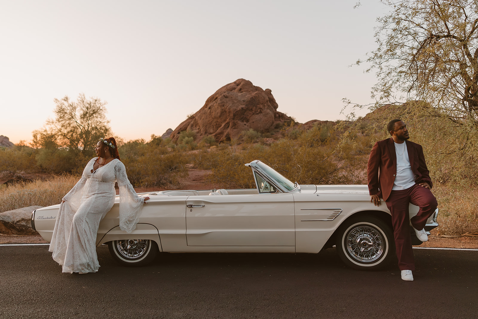 beautiful couple pose with a classic car