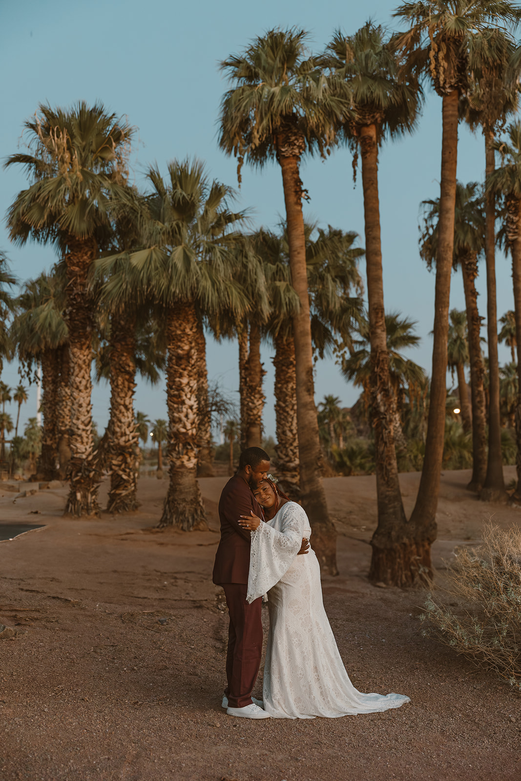 stunning couple pose amongst the palm trees during their engagement shoot