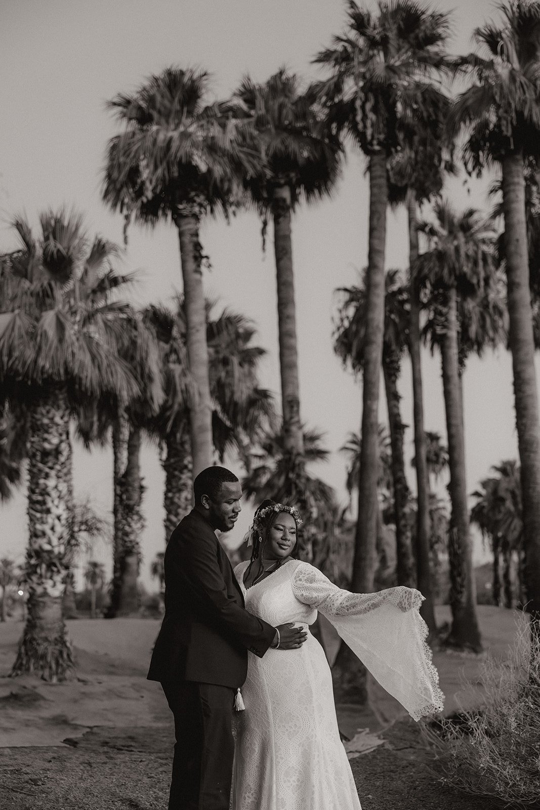 stunning couple pose amongst the palm trees during their engagement shoot
