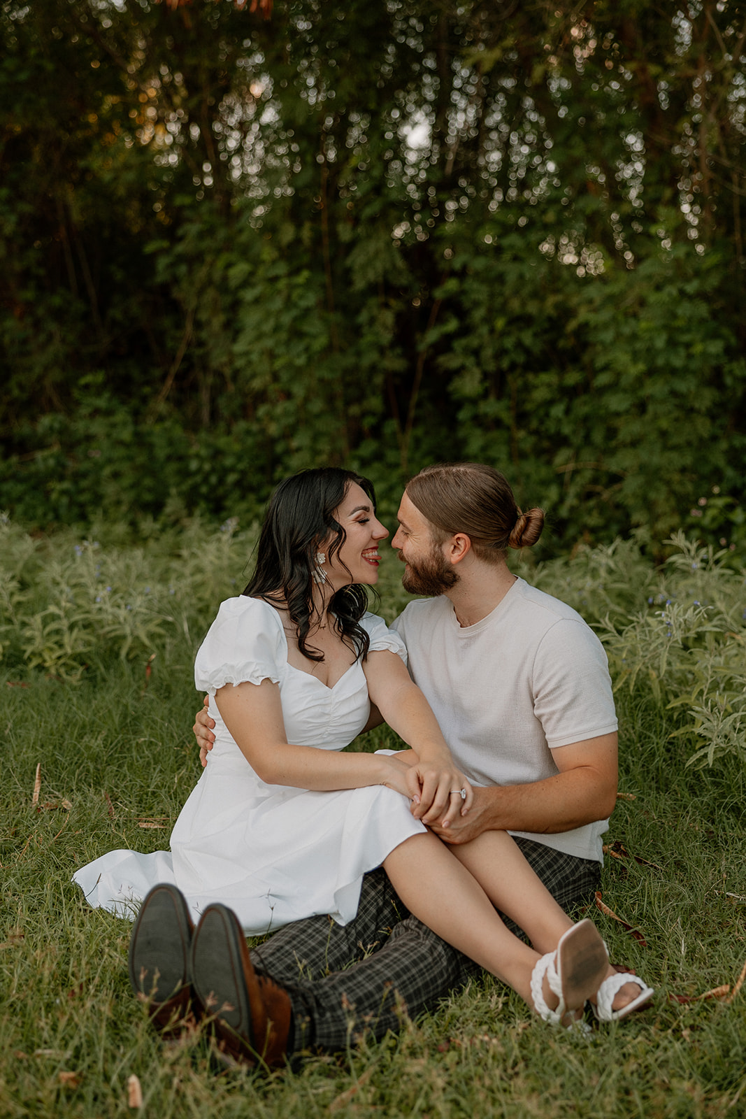 beautiful couple share intimate moments together in the greenery 
