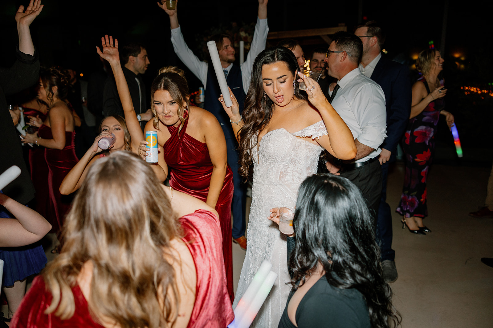The bride dances confidently with her crew during an unforgettable late-night party on the wedding dance floor.

