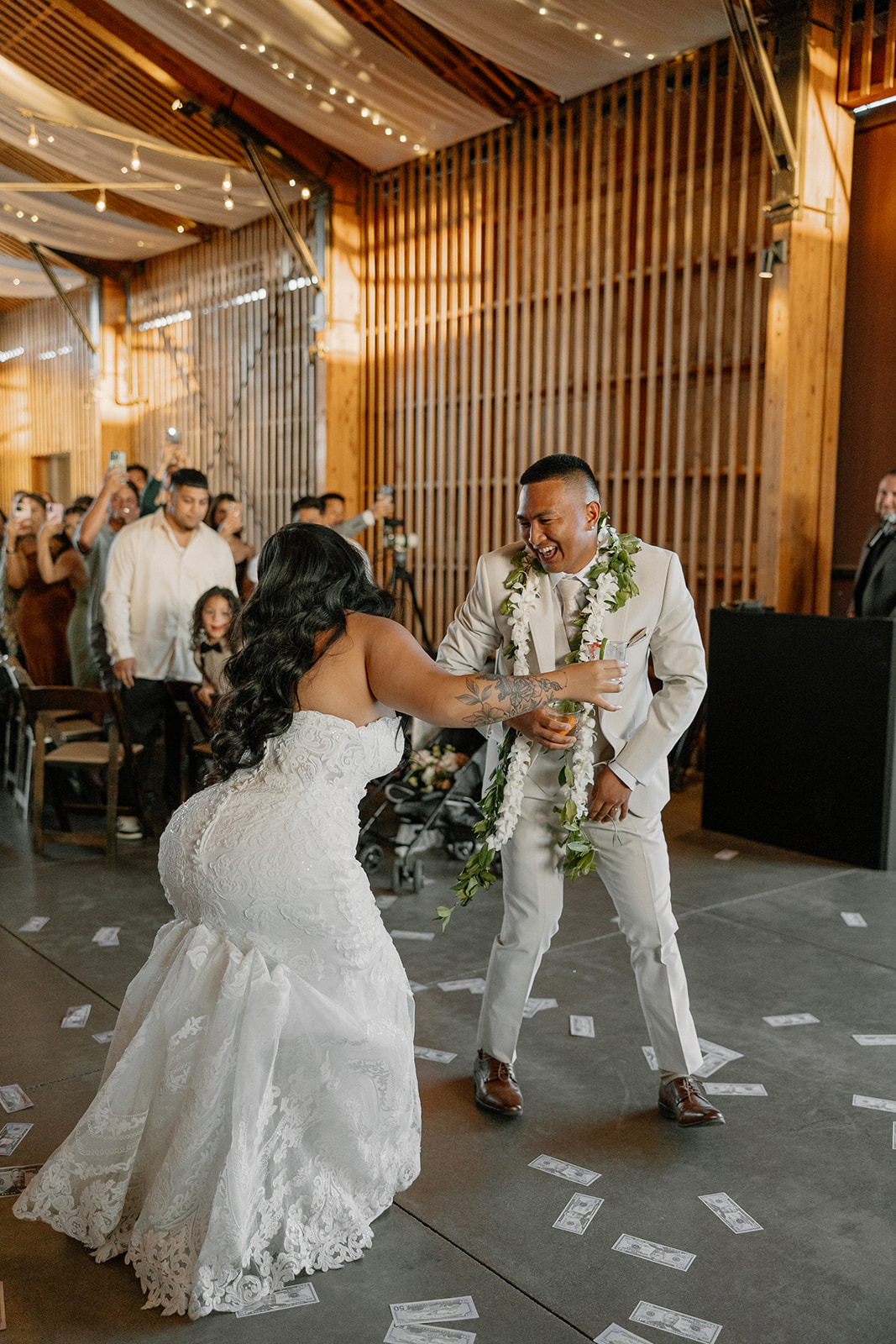 The couple shows off their dance skills while celebrating with guests and dollar bills at their Arizona wedding reception.


