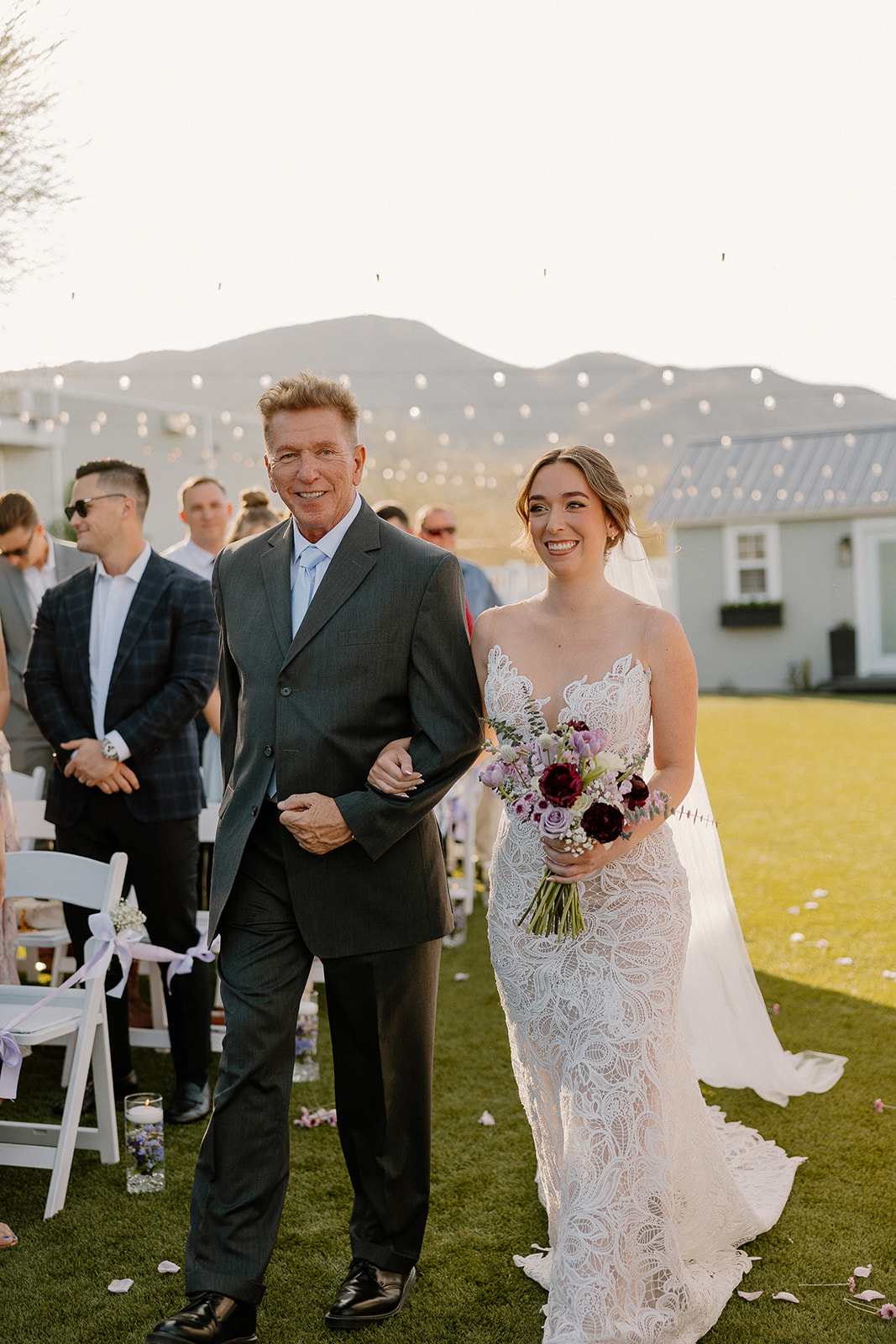 Bride walking down the aisle with her father during sunset at The Cove at Bartlett Lake wedding in Arizona.

