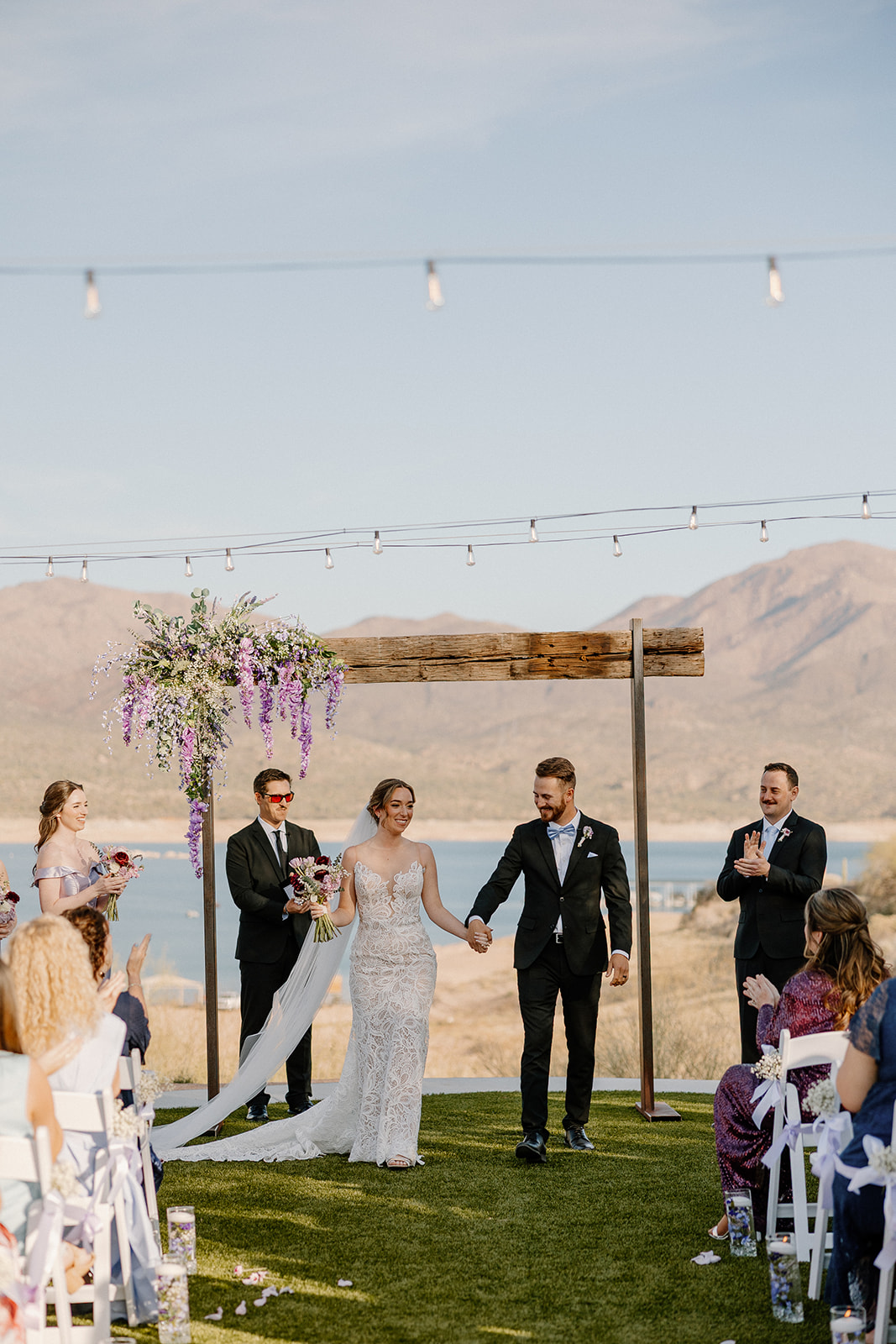 Evening sweetheart table setup with candlelight, purple accents, and mountain views at The Cove at Bartlett Lake wedding reception.