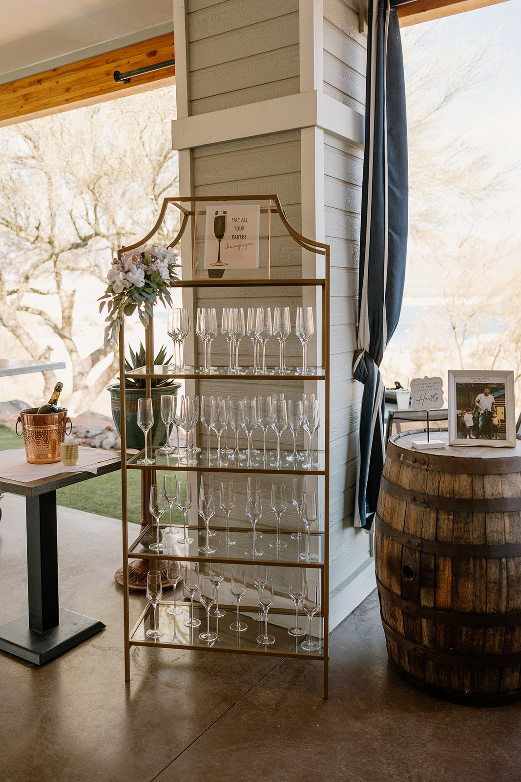 Elegant champagne glass display inside the reception space, styled with florals and rustic details.