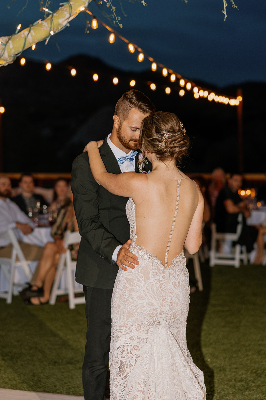 Intimate close-up of the couple’s first dance on the lawn at The Cove at Bartlett Lake wedding celebration.

