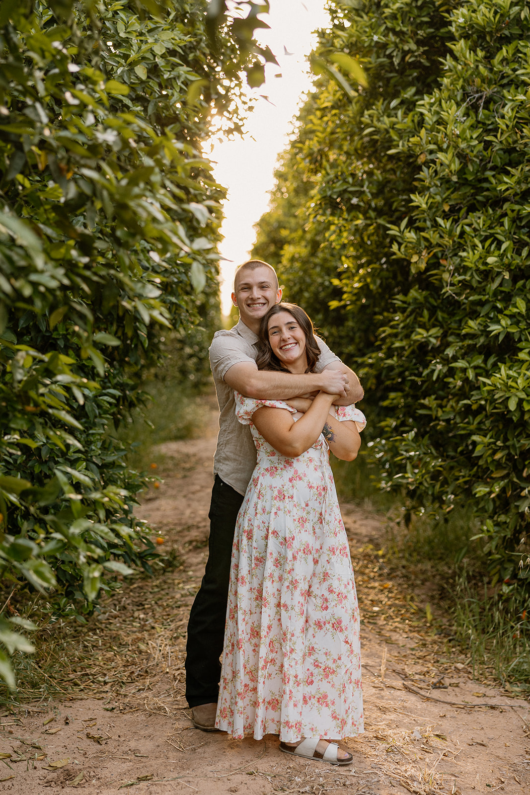 Couple embracing in orange orchard in Arizona