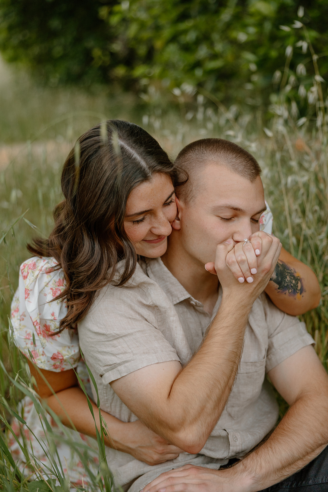 Man kissing fiance's hand during outdoor engagement photos in Sedona Arizona