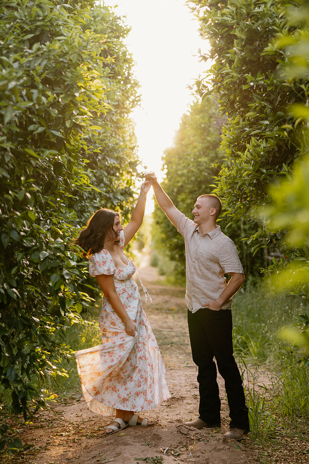 Man and woman dancing in orchard