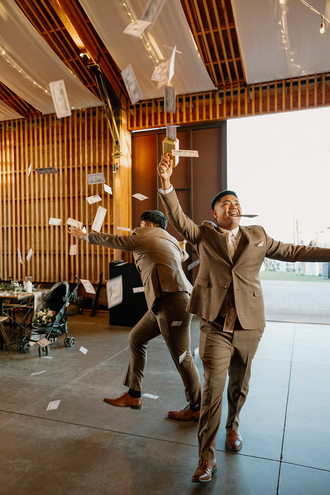 Groomsmen make it rain with fake bills as they enter the reception space, setting the tone for a wild Arizona wedding party.

