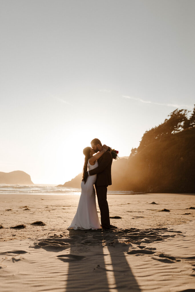 Beachside elopement moment with a full-body hug in front of the crashing waves—proof you don’t need a crowd for a powerful ceremony.
