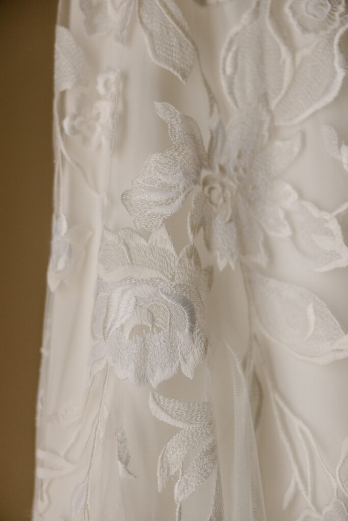 Close-up of floral lace detail on an ivory elopement dresses