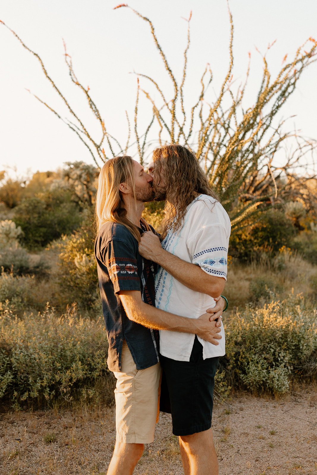 Two grooms kiss after intimate Sedona elopement ceremony surrounded by epic desert views. The ceremony was planned at sunset after deciding what is the best time to elope