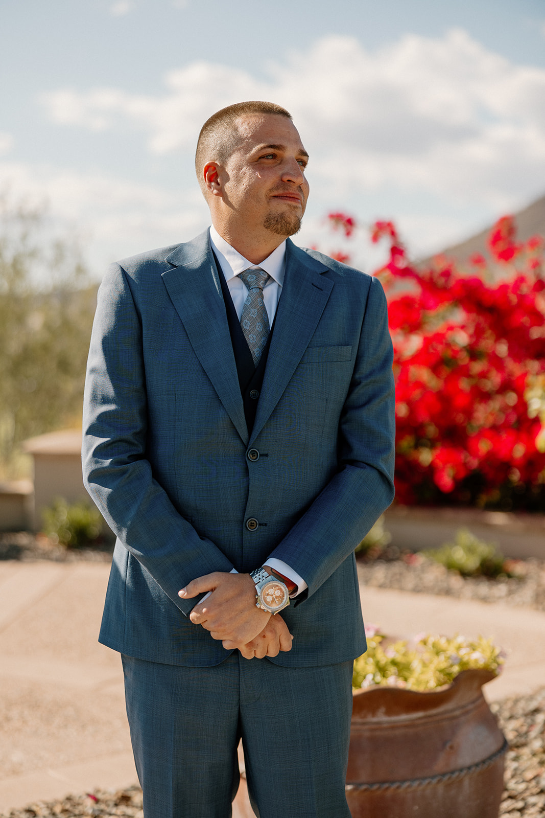 The groom waits at the altar, holding back tears as he sees his bride walking down the aisle toward him.
