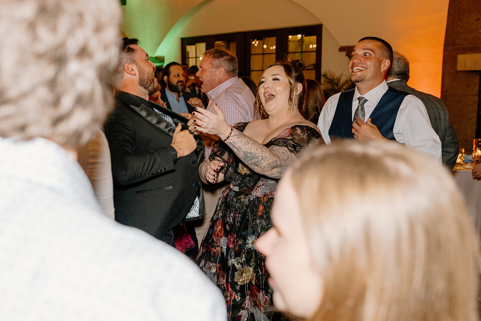 Guests laugh and sing along on the packed Blackstone Country Club dance floor during the evening celebration.