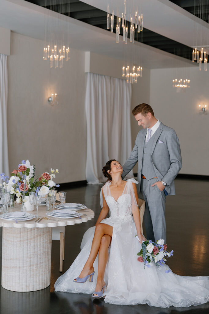 Intimate moment between bride and groom beside a styled reception table inside SoHo63’s Gramercy Ballroom.