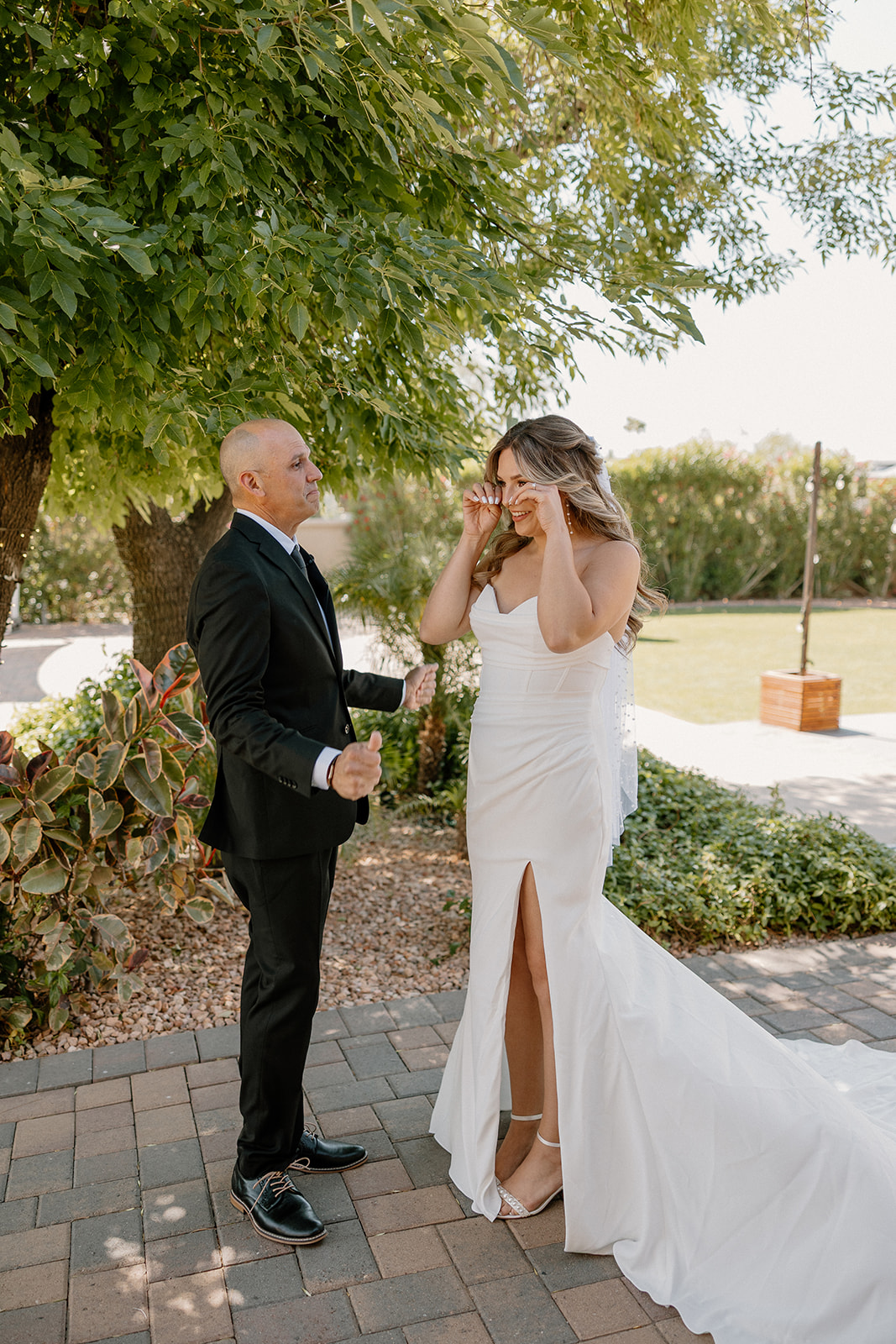 Father and daughter share an emotional moment during their first look outside their Arizona wedding venue.